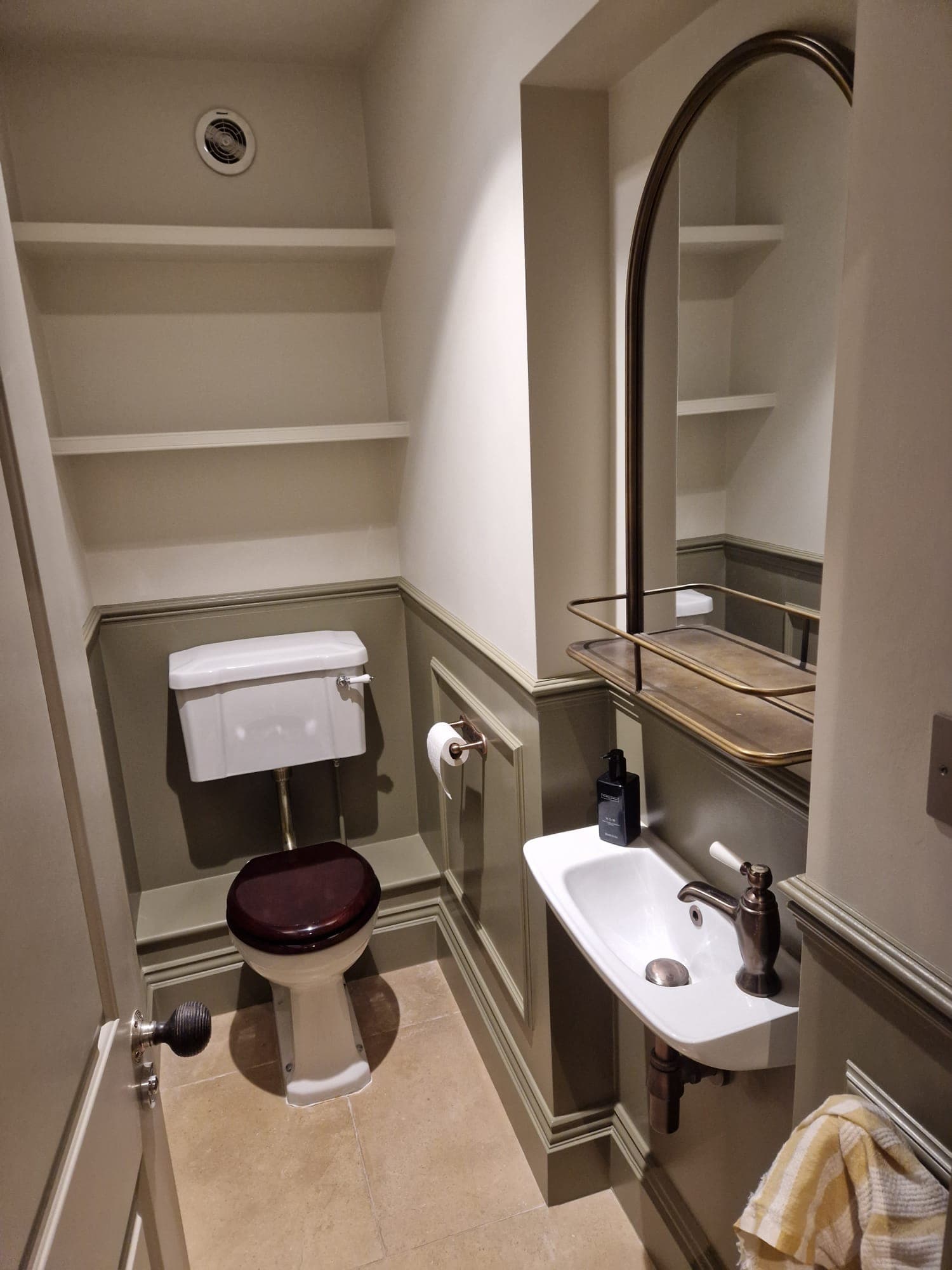 Cloakroom — olive panelling & arch mirror